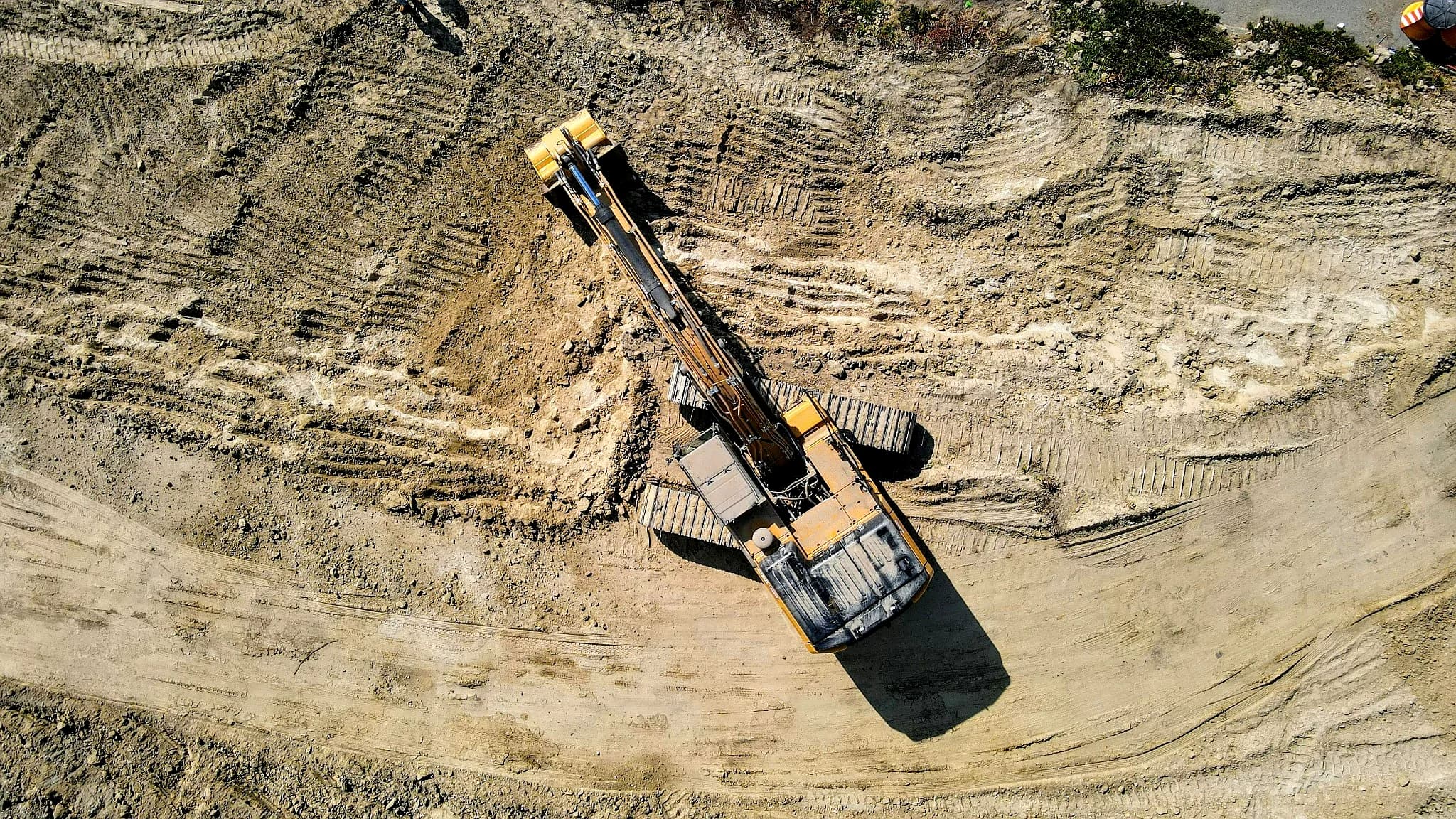 Aerial view of excavation equipment used by Vreeland Roofing for land clearing and site preparation in Florida.